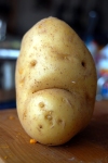 A picture of a potato with a sad face